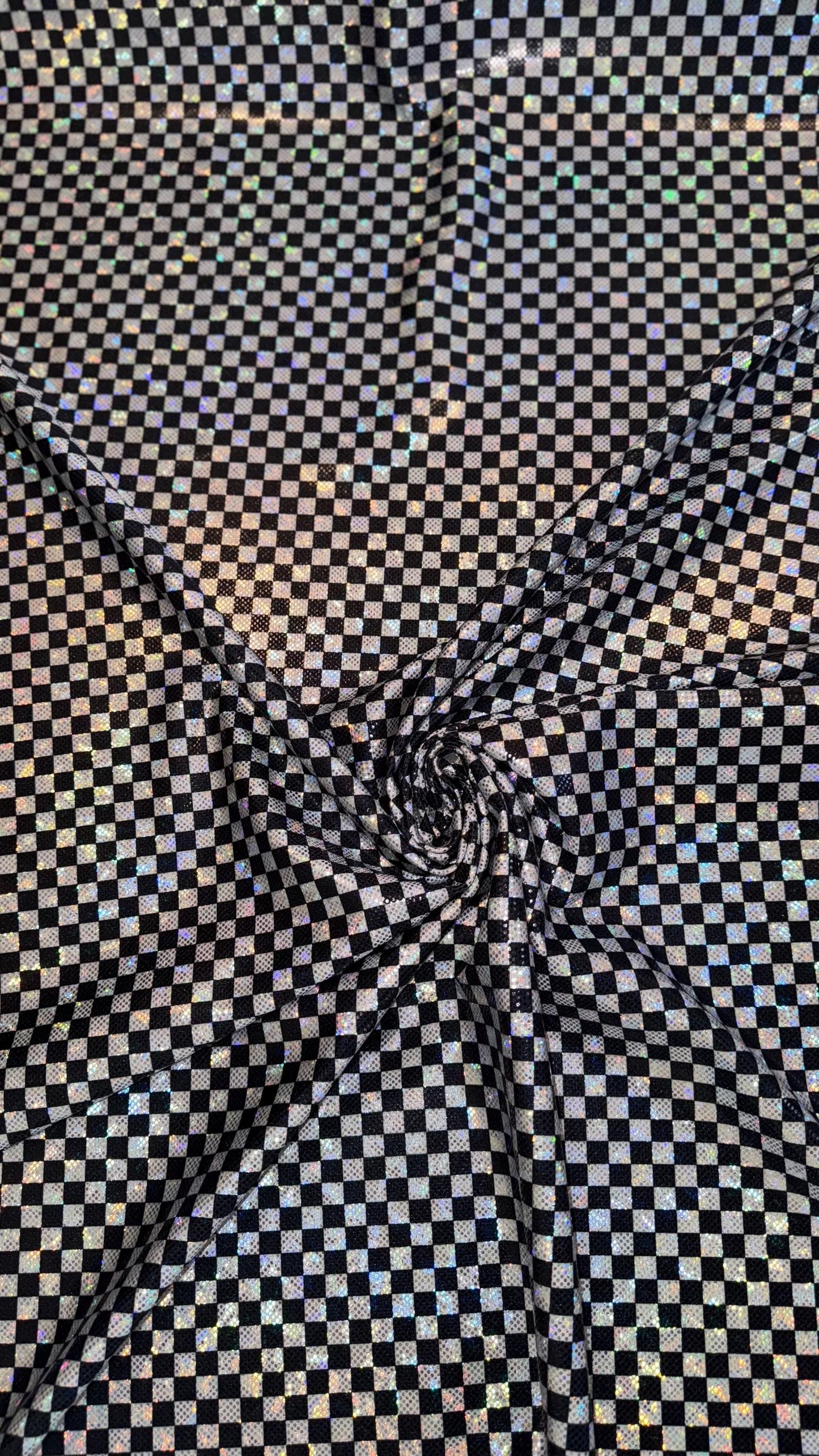 Checkers design Small size on shattered glass New metallic hologram nylon spandex 4-way stretch 58/60” Sold by the YD. Ships worldwide
