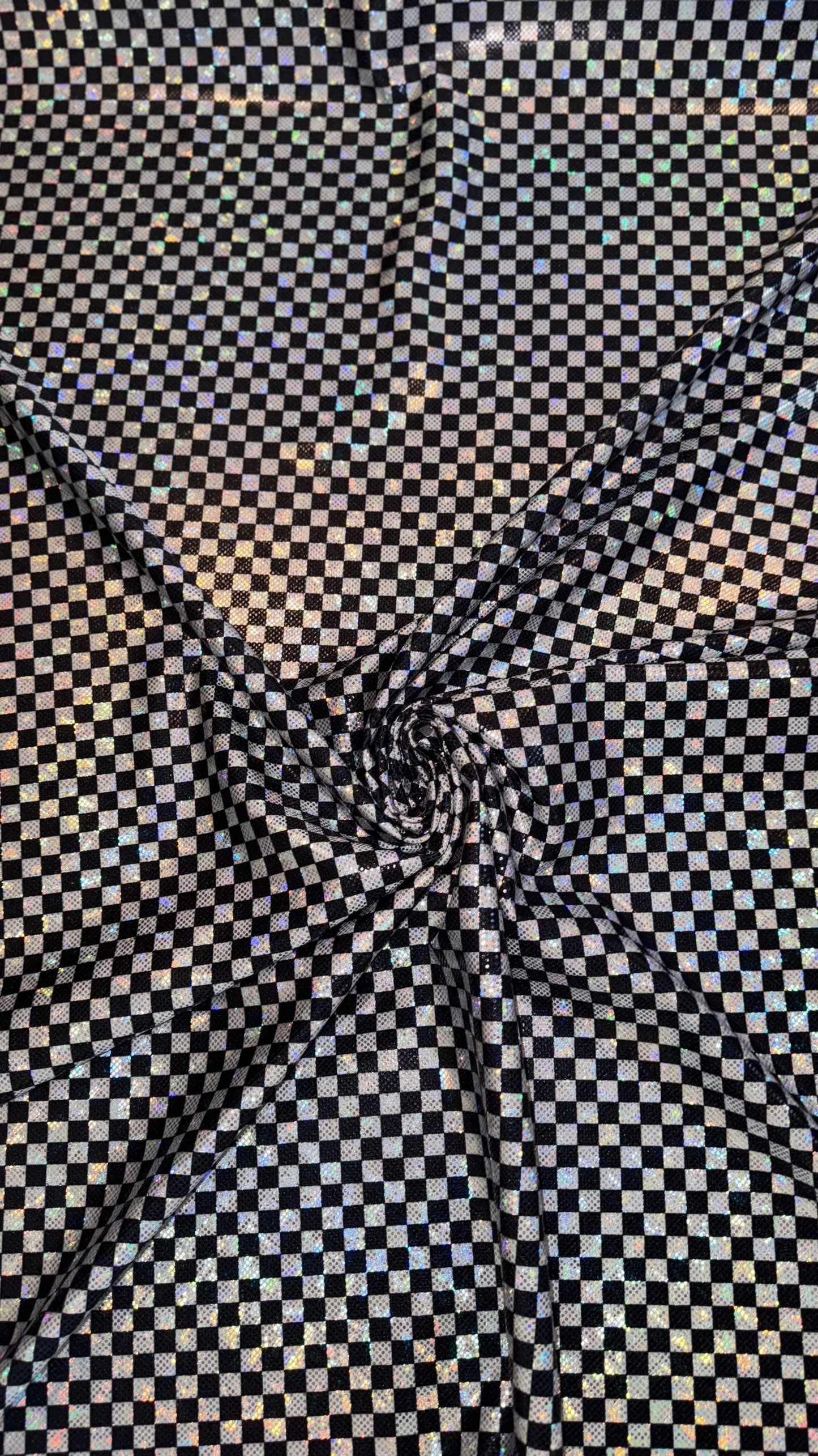 Checkers design Small size on shattered glass New metallic hologram nylon spandex 4-way stretch 58/60” Sold by the YD. Ships worldwide