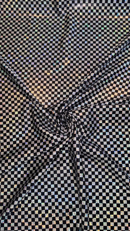 Checkers design Small size on shattered glass New metallic hologram nylon spandex 4-way stretch 58/60” Sold by the YD. Ships worldwide