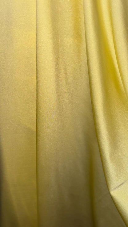 Great quality shiny Soft yellow  nylon spandex 4-way stretch 58/60” Sold by the YD. Ships worldwide from Los Ángeles California USA.