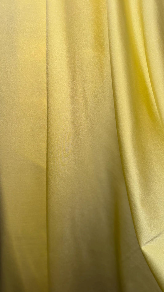 Great quality shiny Soft yellow  nylon spandex 4-way stretch 58/60” Sold by the YD. Ships worldwide from Los Ángeles California USA.