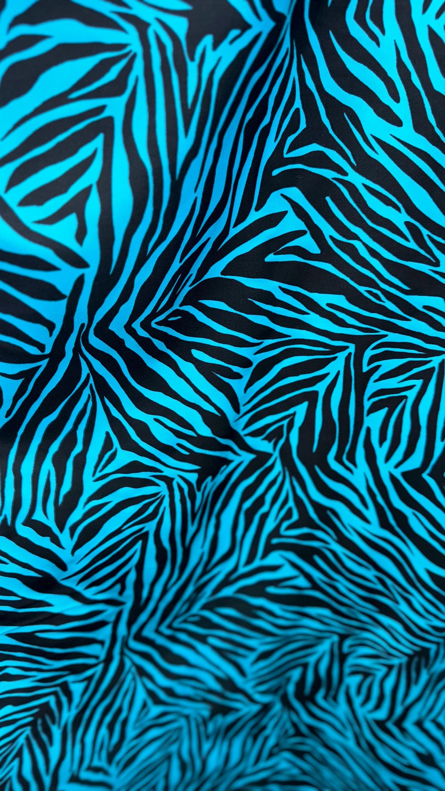 New zebra design turquois/Black print on nylon spandex 4way stretch 58/60" Sold by the YD. Ships worldwide from Los Angeles California USA.