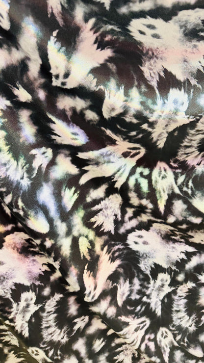 Ghost Hollowen design on Iridescent metallic nylon spandex with foggy foil 4-way stretch 58/60” Sold by the YD. Ships worldwide from LA CA