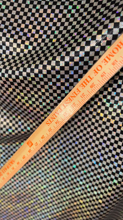 Checkers design Small size on shattered glass New metallic hologram nylon spandex 4-way stretch 58/60” Sold by the YD. Ships worldwide