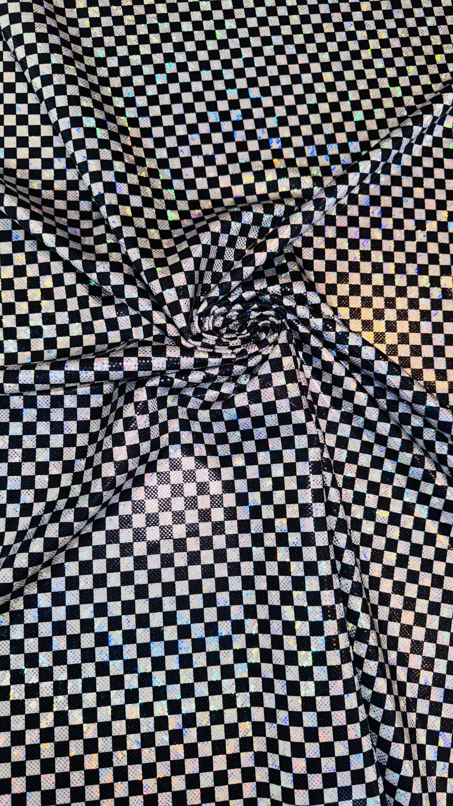 Checkers design Small size on shattered glass New metallic hologram nylon spandex 4-way stretch 58/60” Sold by the YD. Ships worldwide