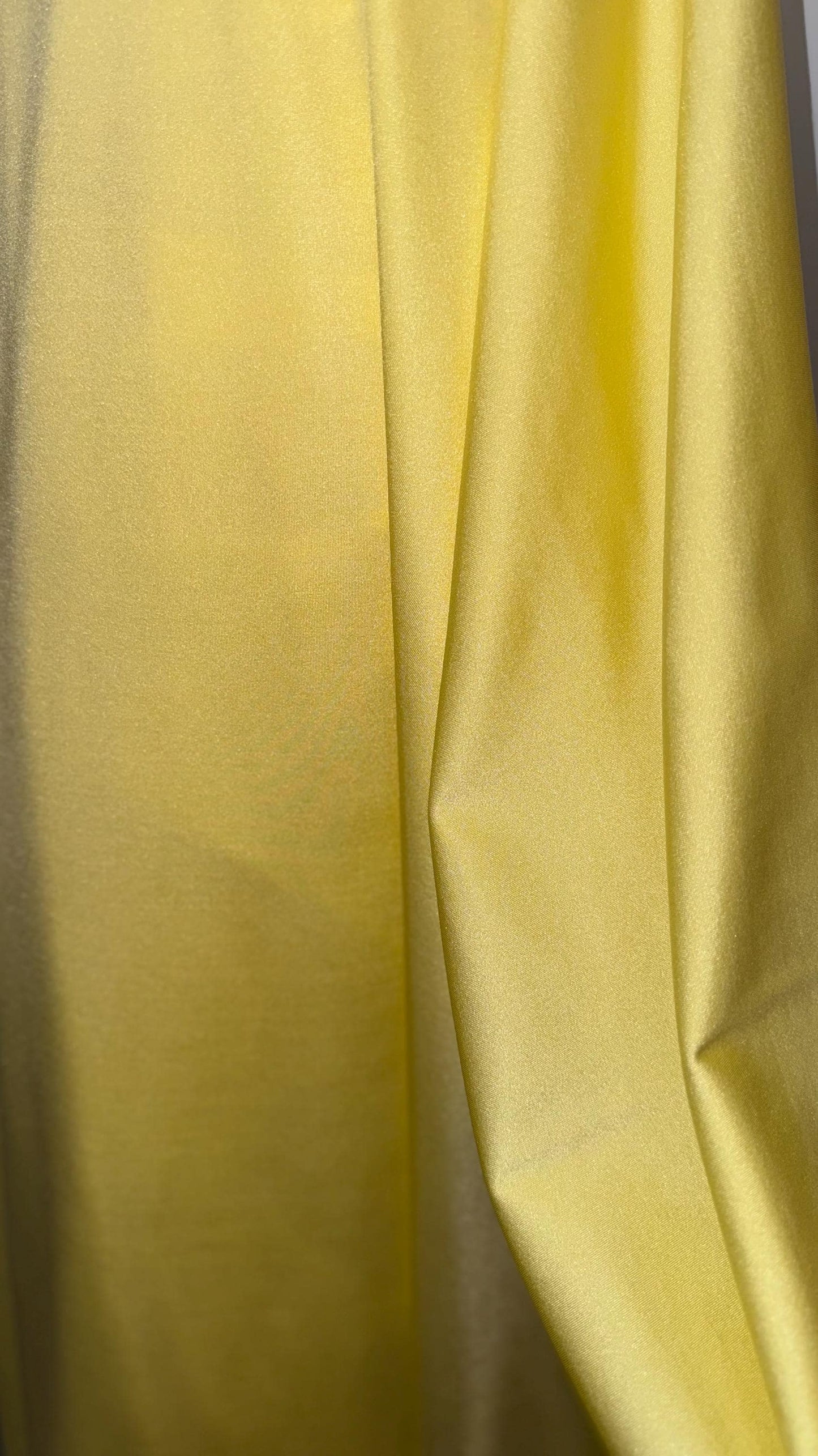 Great quality shiny Soft yellow  nylon spandex 4-way stretch 58/60” Sold by the YD. Ships worldwide from Los Ángeles California USA.