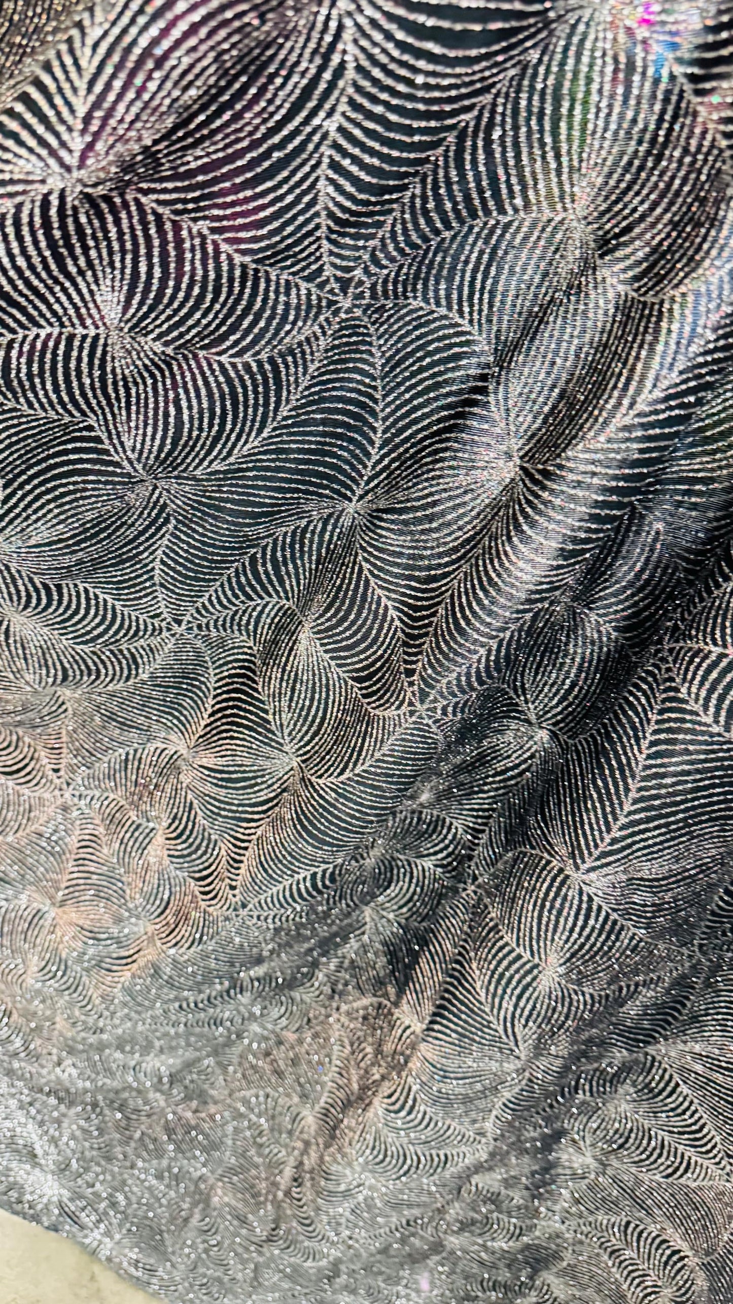 Slinky spider web design with glitter black/silver 4way stretch 58/60" Sold by the YD. Ships worldwide from Los Angeles California USA.