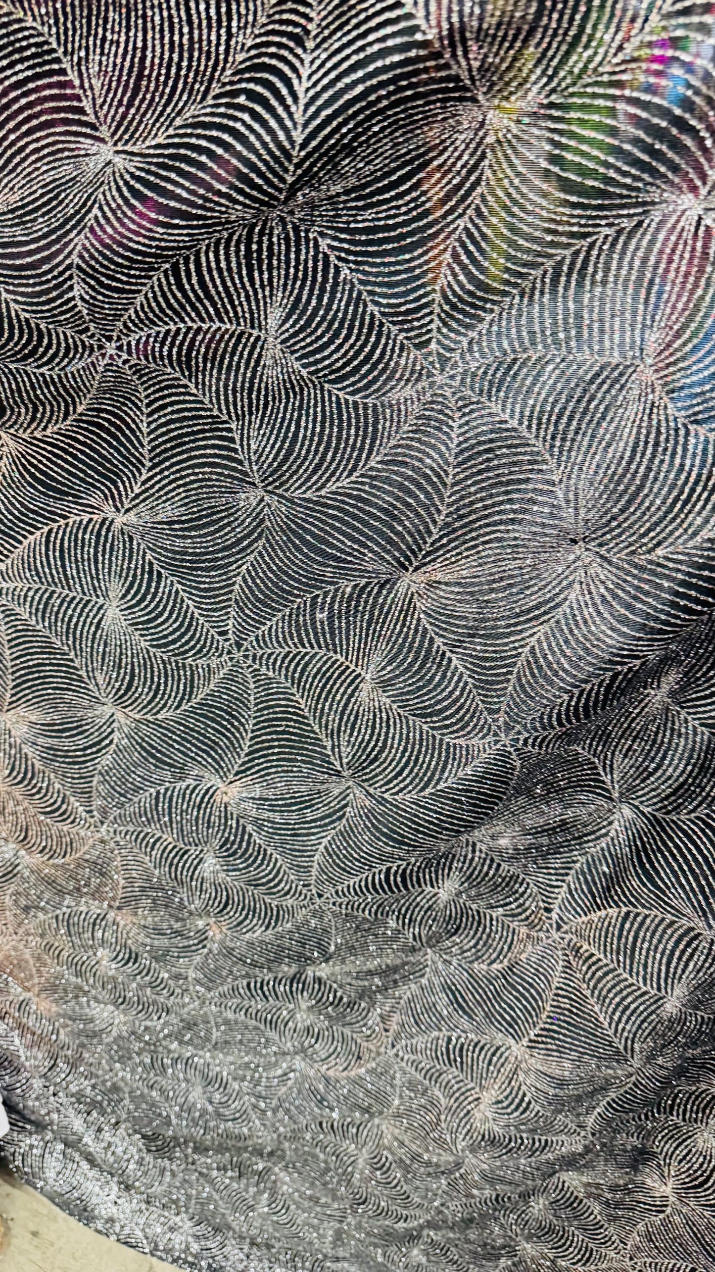 Slinky spider web design with glitter black/silver 4way stretch 58/60" Sold by the YD. Ships worldwide from Los Angeles California USA.