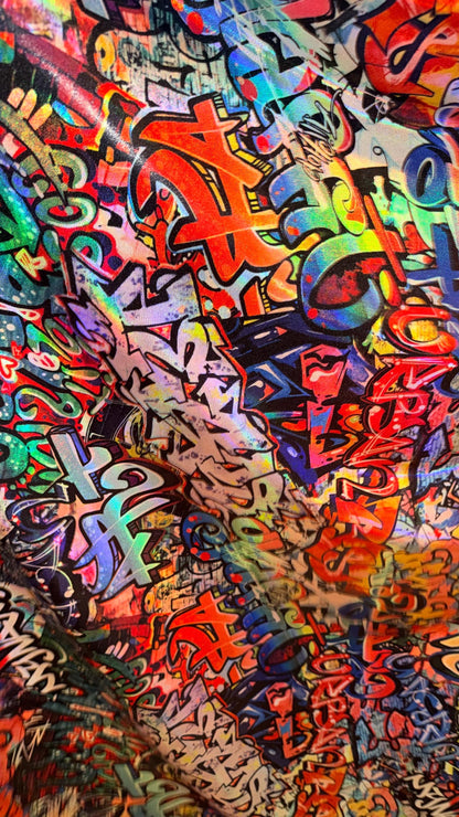 Graffiti design Multicolor on Iridescent metallic hologram nylon spandex  4-way stretch 58/60” Sold by the YD.  High quality fabrics