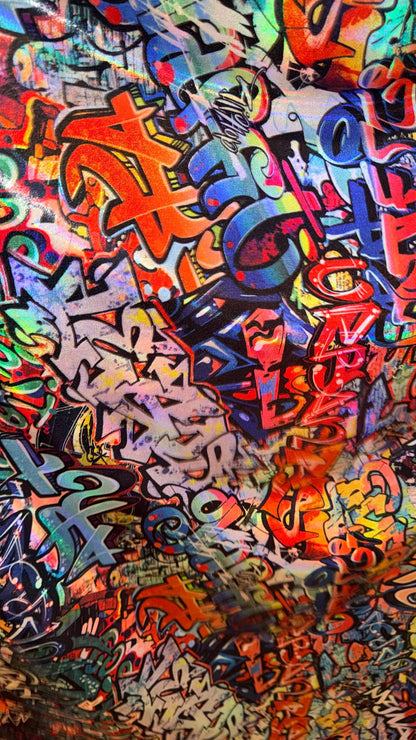 Graffiti design Multicolor on Iridescent metallic hologram nylon spandex  4-way stretch 58/60” Sold by the YD.  High quality fabrics
