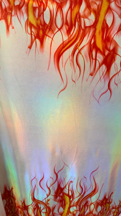 Flames design Black/Fire and White/Sapphire on Iridescent Hologram metallic nylon spandex 4-way stretch 58/60” Sold by the YD.