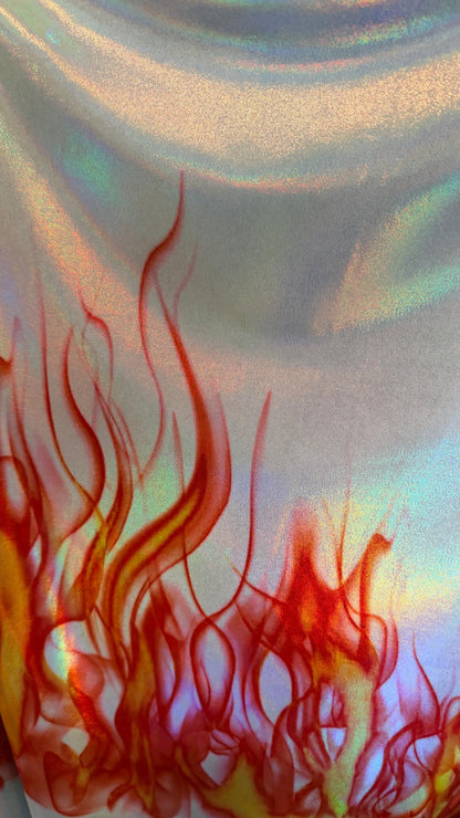 Flames design Black/Fire and White/Sapphire on Iridescent Hologram metallic nylon spandex 4-way stretch 58/60” Sold by the YD.