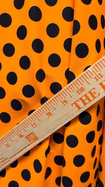 New polka dots design neon orange with black dots nylon spandex 4-way stretch 58/60” Sold by the YD. Ships worldwide from Los Angeles CA