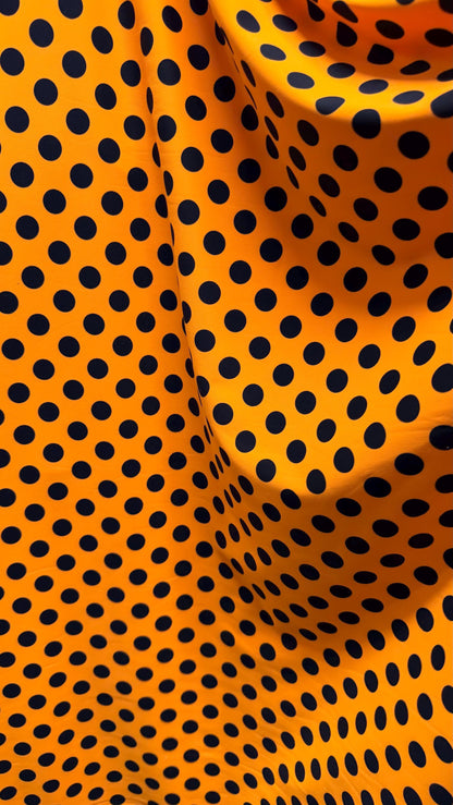 New polka dots design neon orange with black dots nylon spandex 4-way stretch 58/60” Sold by the YD. Ships worldwide from Los Angeles CA