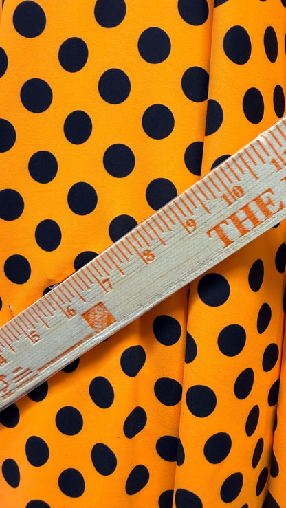 New polka dots design neon orange with black dots nylon spandex 4-way stretch 58/60” Sold by the YD. Ships worldwide from Los Angeles CA