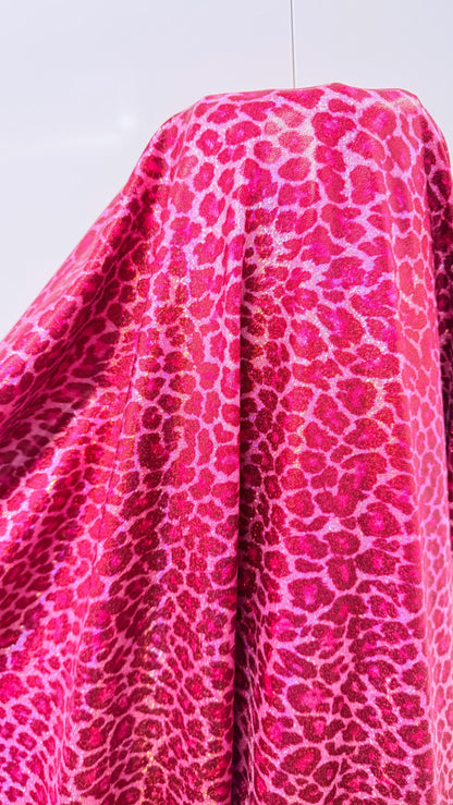 Wild Cheetah design Pink Color on hologram metallic foggy foil nylon spandex 4-way stretch 58/60” Sold by the YD.