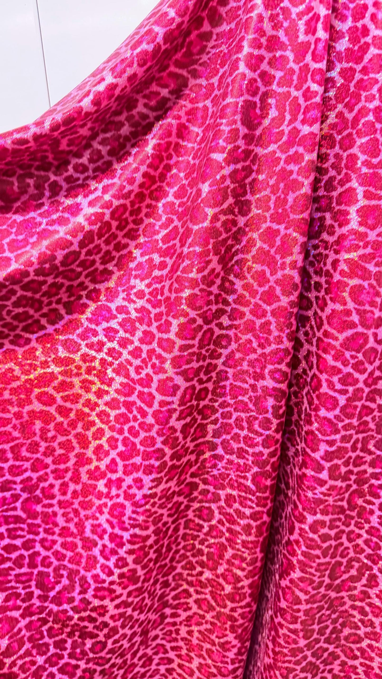 Wild Cheetah design Pink Color on hologram metallic foggy foil nylon spandex 4-way stretch 58/60” Sold by the YD.