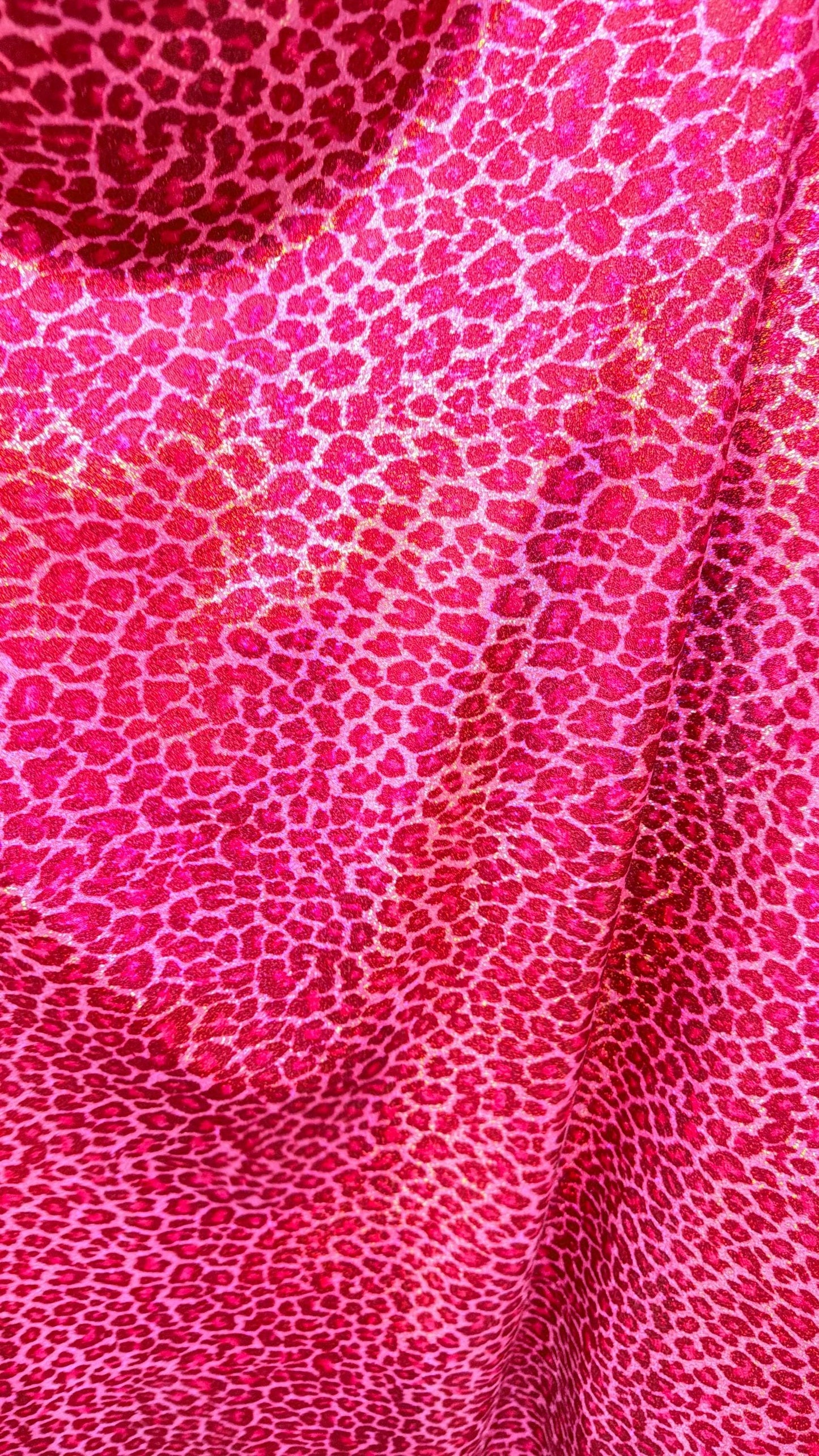 Wild Cheetah design Pink Color on hologram metallic foggy foil nylon spandex 4-way stretch 58/60” Sold by the YD.