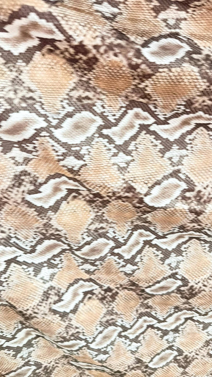 New Mamba Exotic snake design Taupe/black print on best quality of nylon spandex 4-way stretch 58/60” Sold by the YD. Ships worldwide