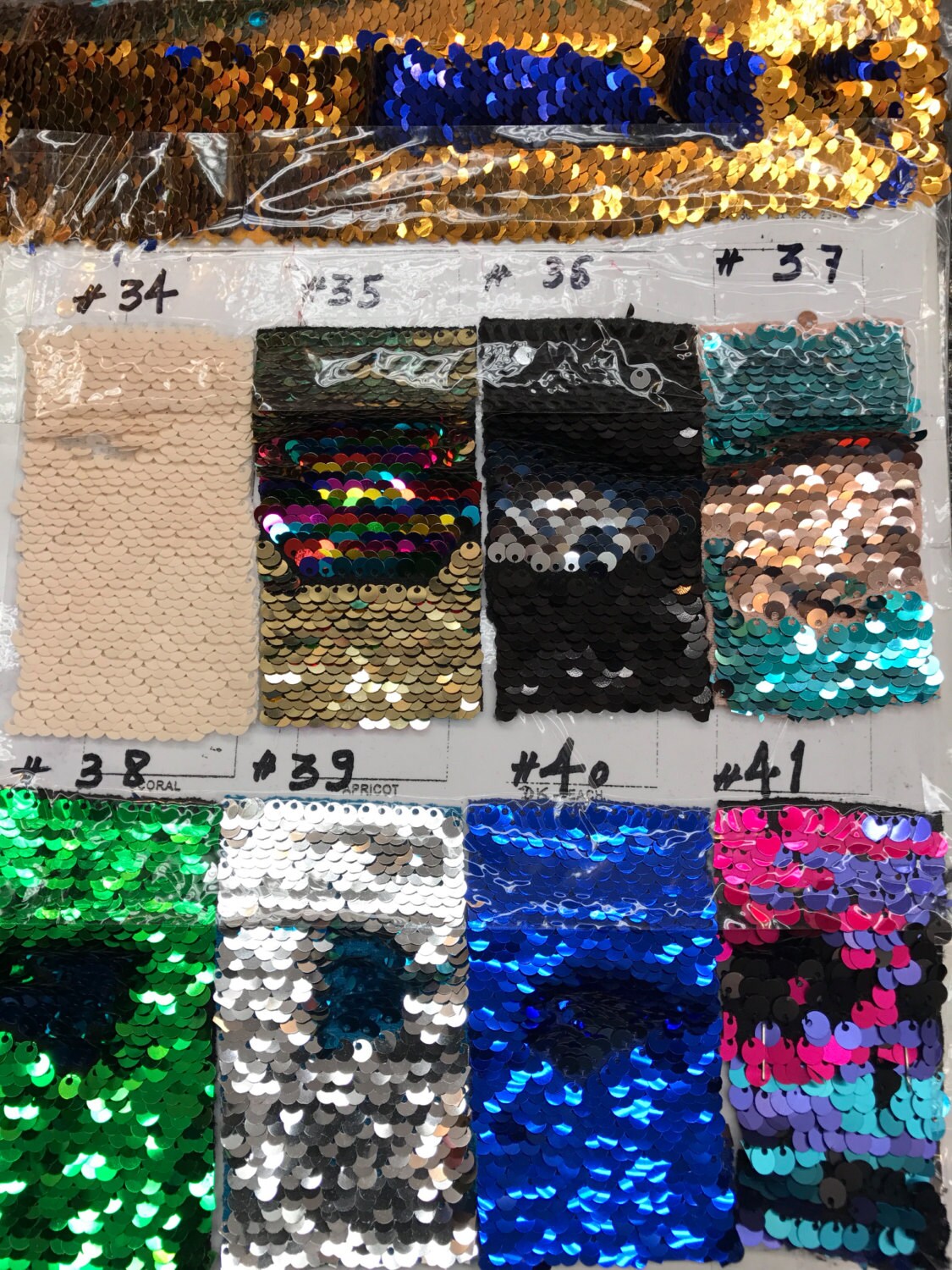 Flip up mermaid sequins turquoise/kelly green  2 tone sequins with spandex base. Sold by the yd Ships worldwide from Los Angeles California