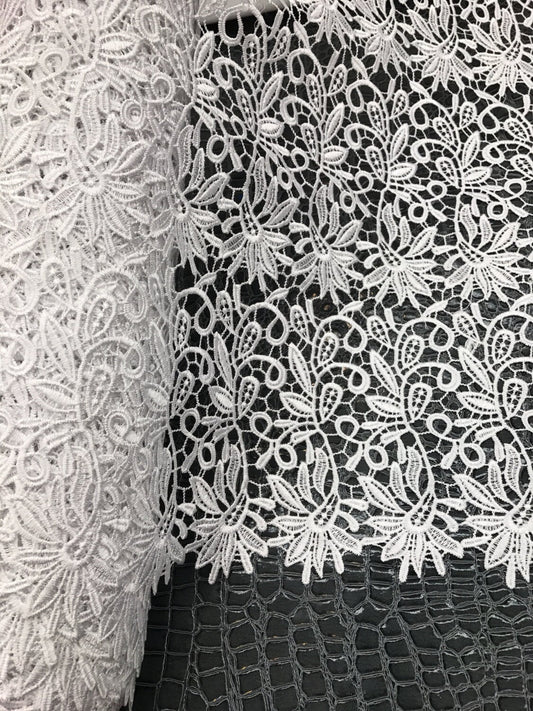 French white guipuir floral design 50/52" 100% poly sold by the YD. Ships worldwide from Los Angeles California United States.