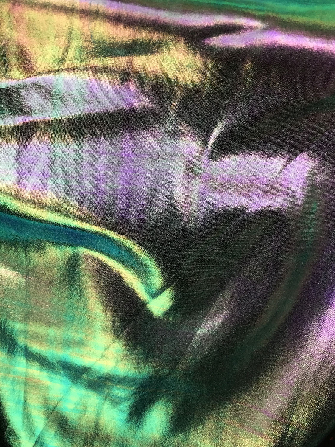 Iridescent all over foil silver green nylon spandex 4 Way stretch 58/60" Sold by the YD. Ships worldwide from Los Angeles California USA.