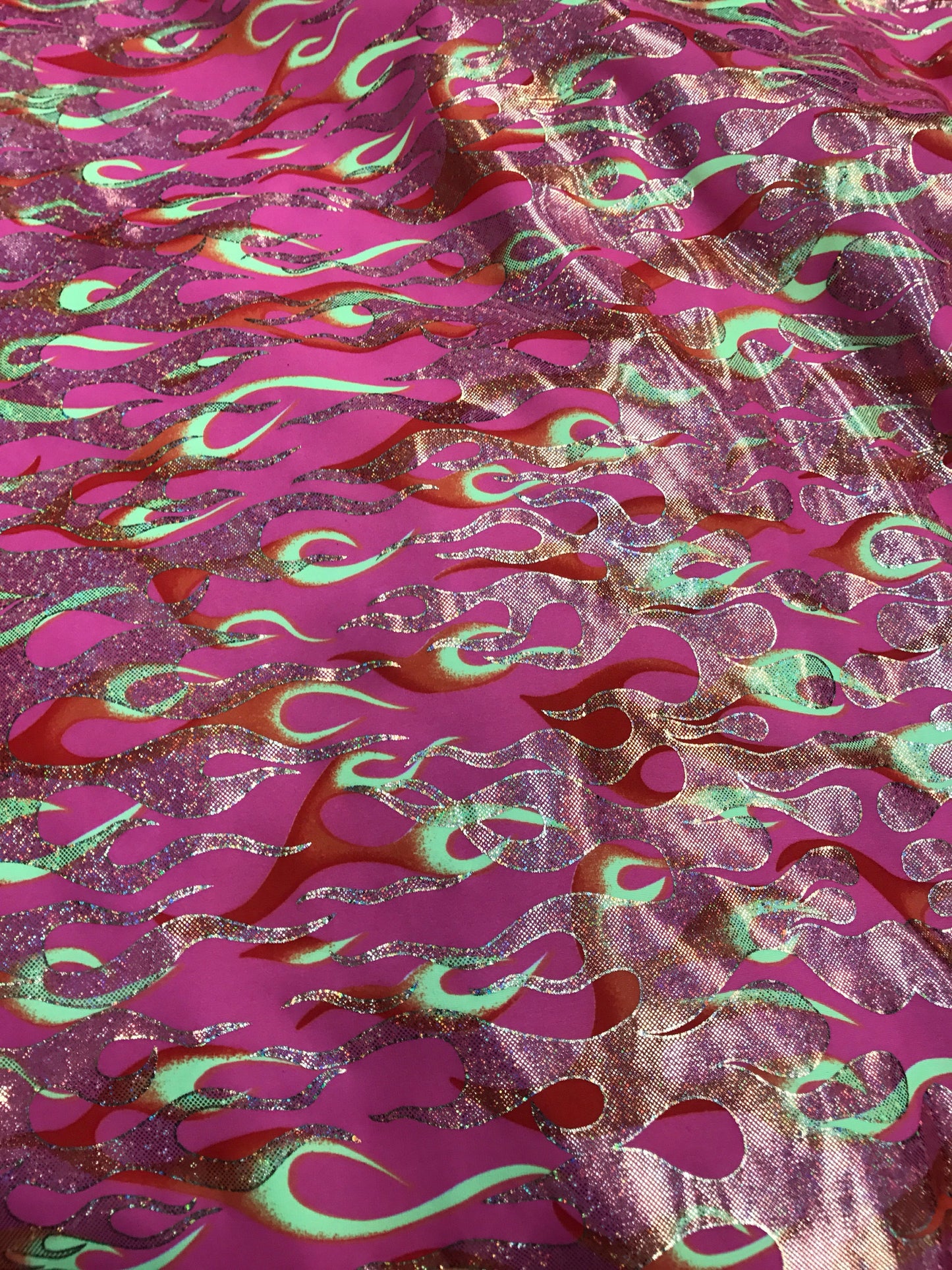 Flame design Hologram pink on nylon spandex 4 way stretch 58/60" Sold by the YD. Ships worldwide from Los Angeles California USA