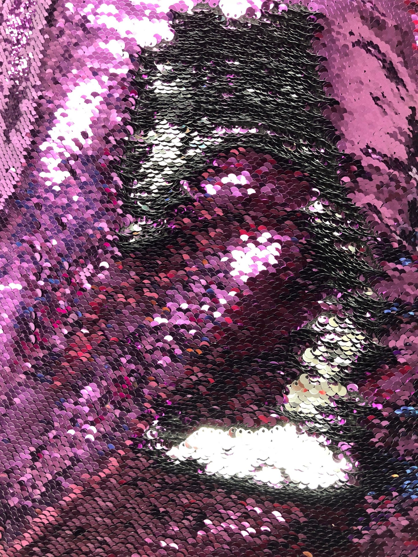 Flip up sequins eggplant/silver reversible sequins in spandex base 58/60" Sold by the YD. Ships worldwide from Los Angeles California USA.