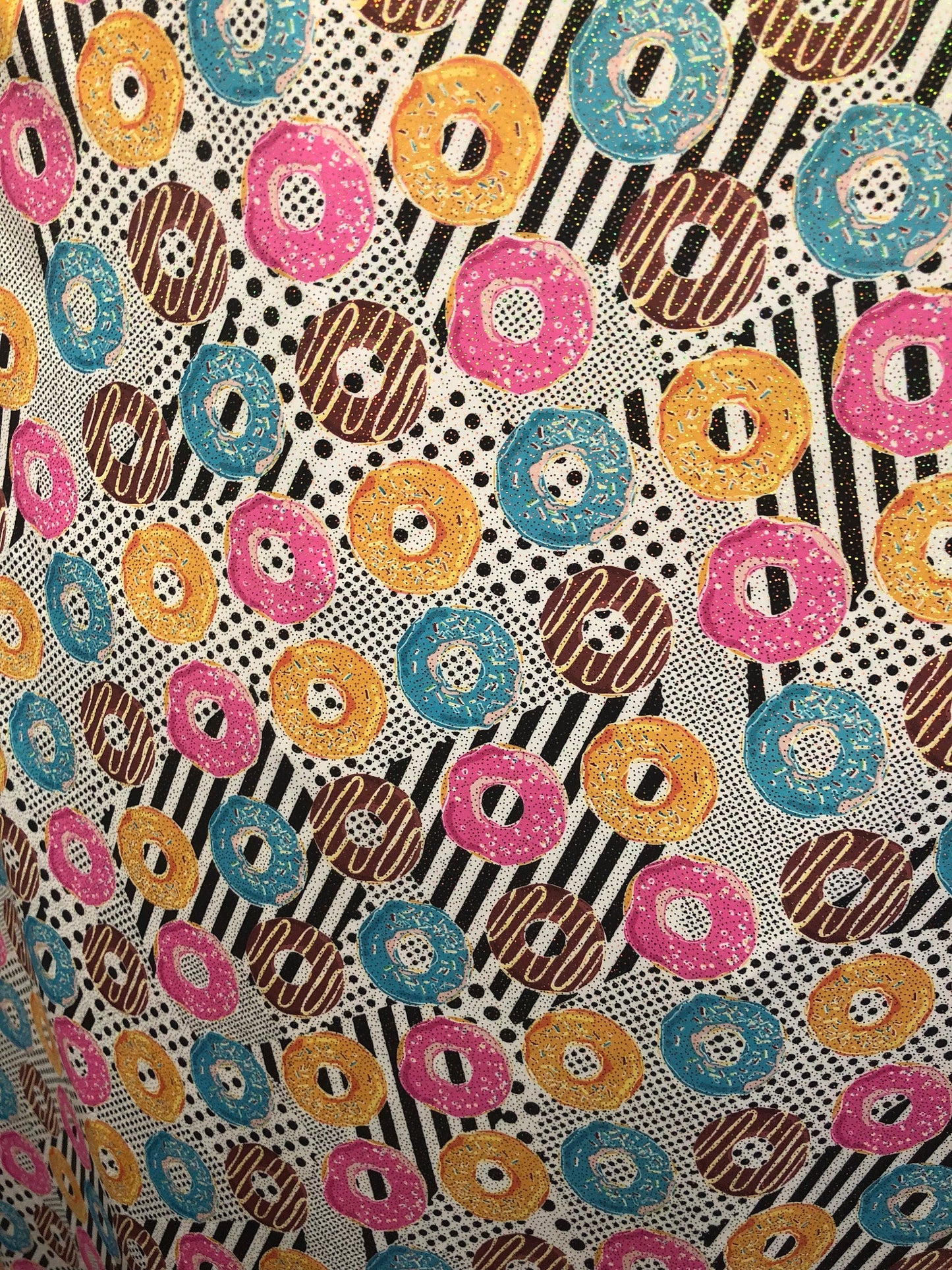 New nylon spandex print with foil all over yum yum donuts design 58/60" Sold by ghe YD. Ships worldwide from Los Angeles California USA.