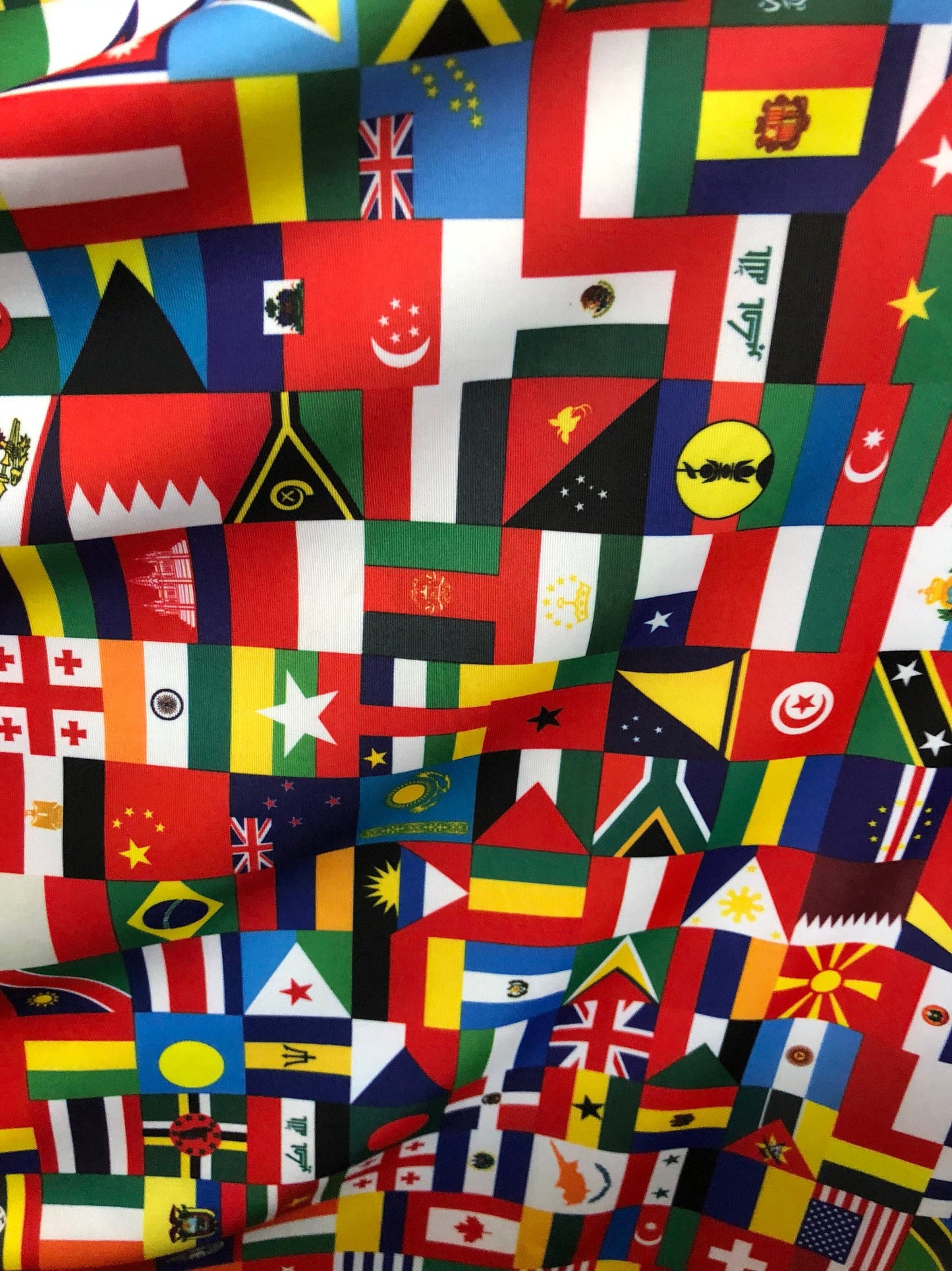 New International multi flags design printed on nylon spandex 4way stretch 58/60" Sold by the YD. Ships worldwide from Los Angeles CA USA.