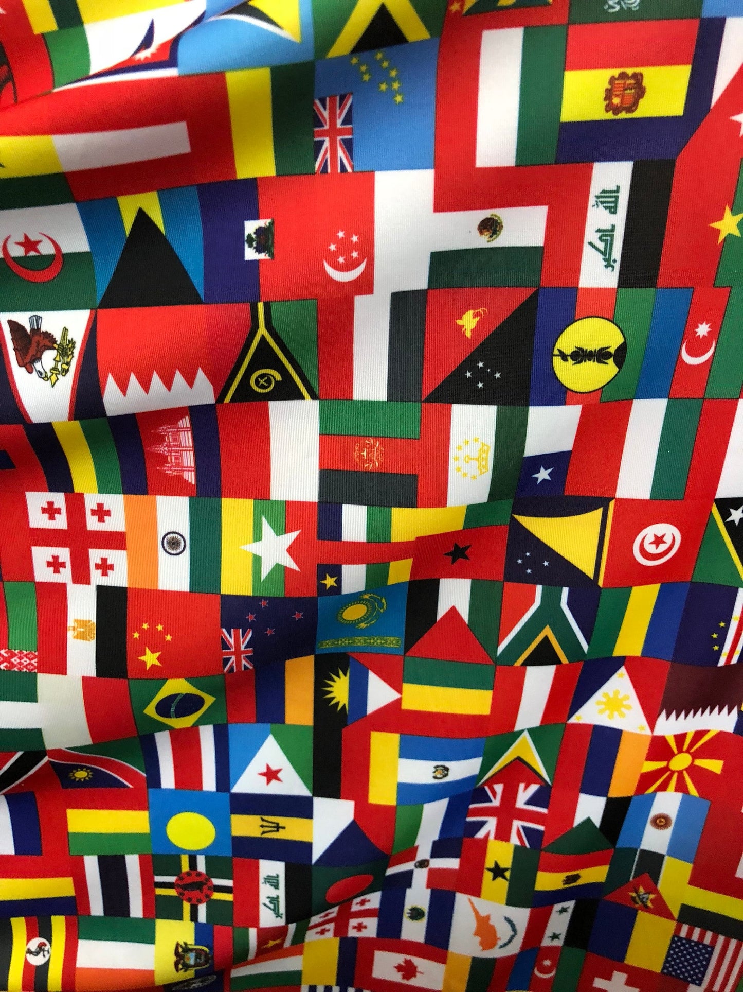 New International multi flags design printed on nylon spandex 4way stretch 58/60" Sold by the YD. Ships worldwide from Los Angeles CA USA.