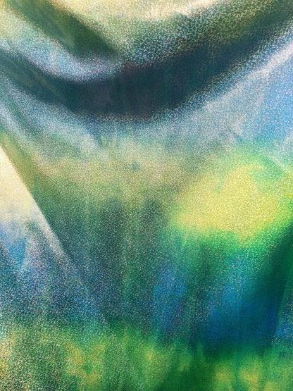 New hologram metallic tie dye blue/green on spandex base 4way stretch 58/60" Sold by the YD. Ships worldwide from Los Ángeles California.