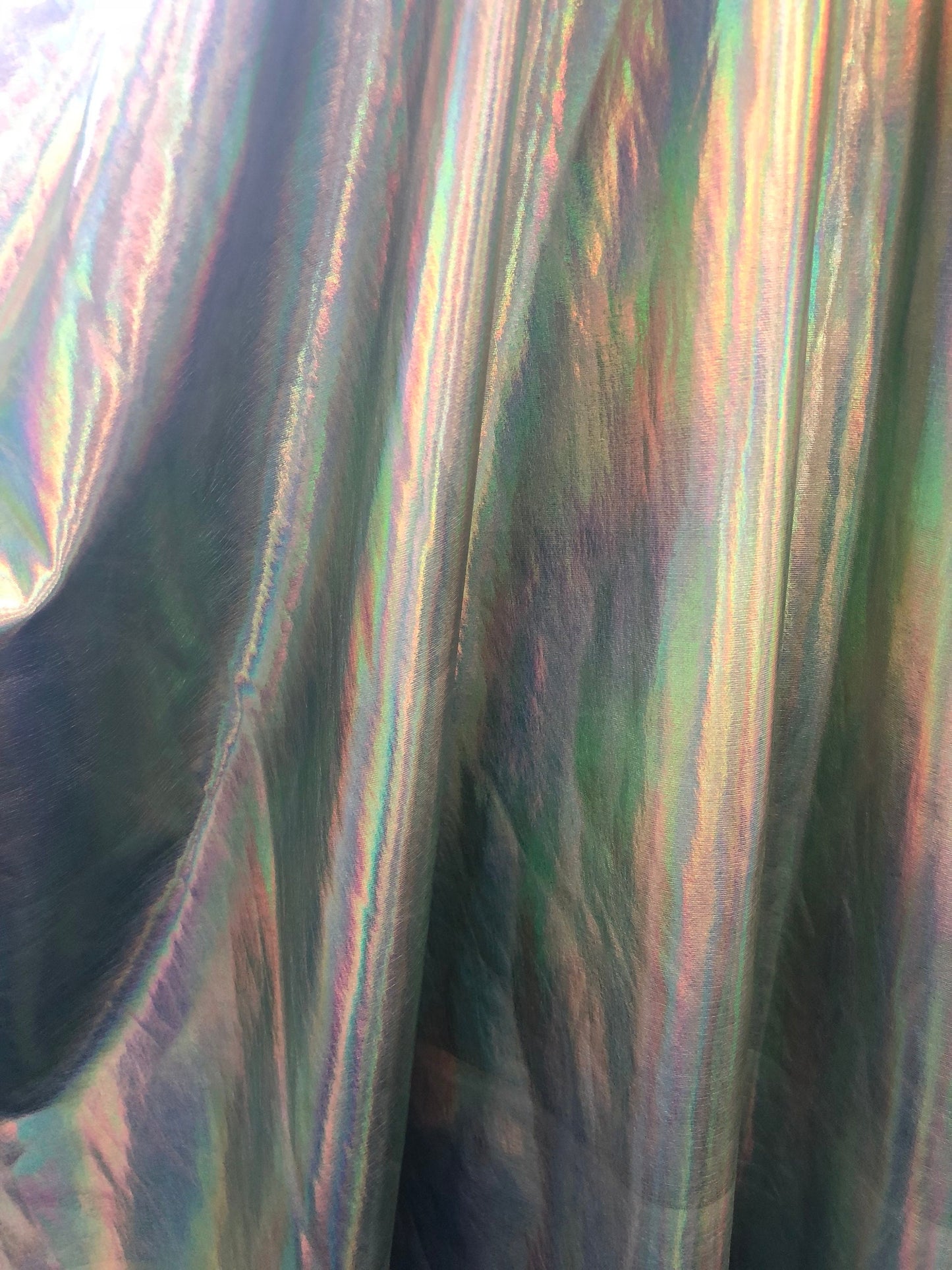 New iridescent olive foil metallic nylon spandex 4way stretch 58/60" Sold by the YD. Ships worldwide from Los Angeles California USA.