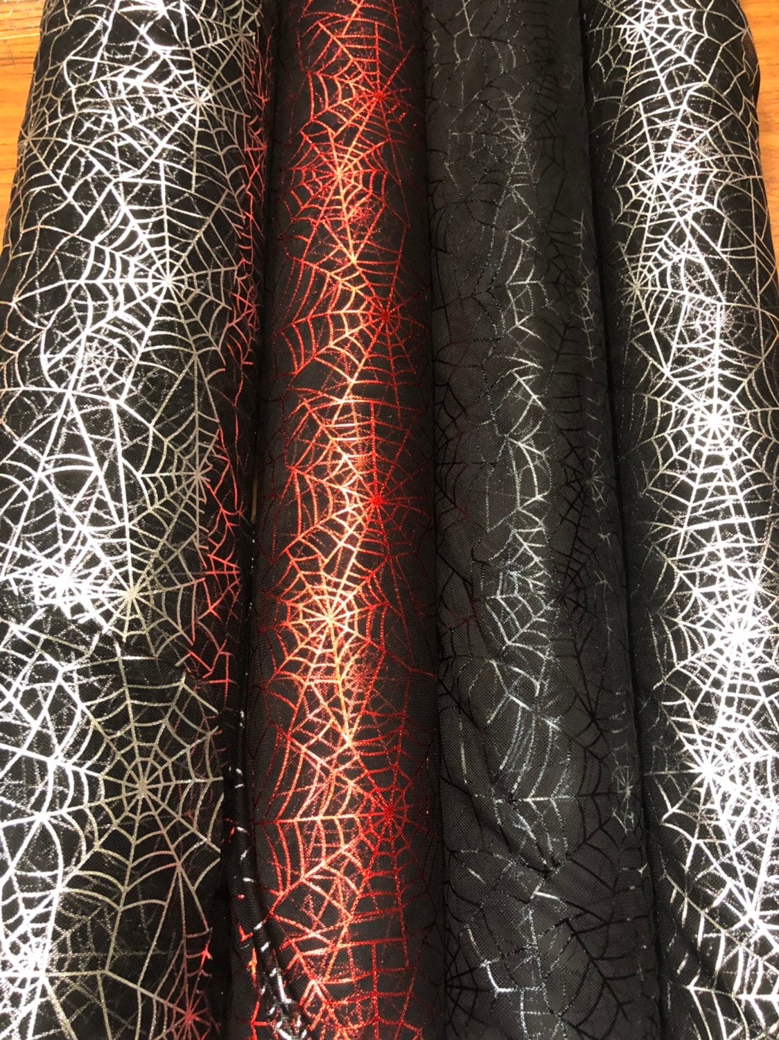 Spider web design with metallic foil on poly mesh 2way stretch 58/60" Sold by the YD. Ships worldwide from Los Angeles California USA.