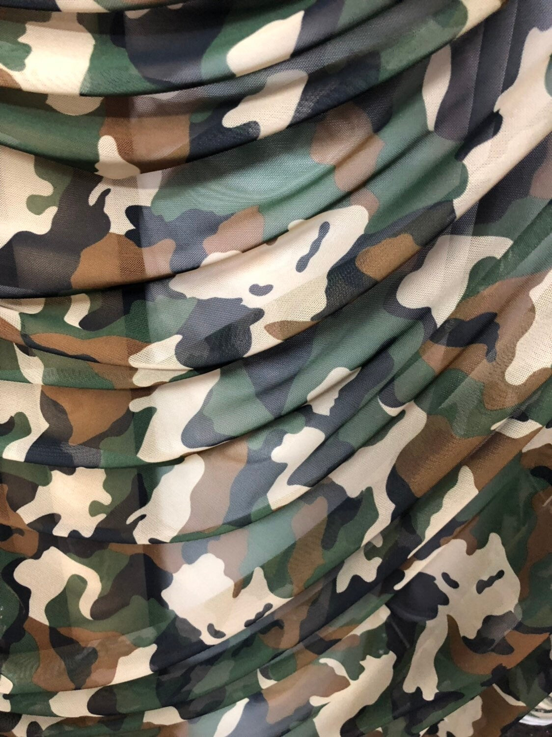 Camouflage design on power mesh 4way stretch 58/60" Sold by the YD. Ships worldwide from Los Angeles California USA.