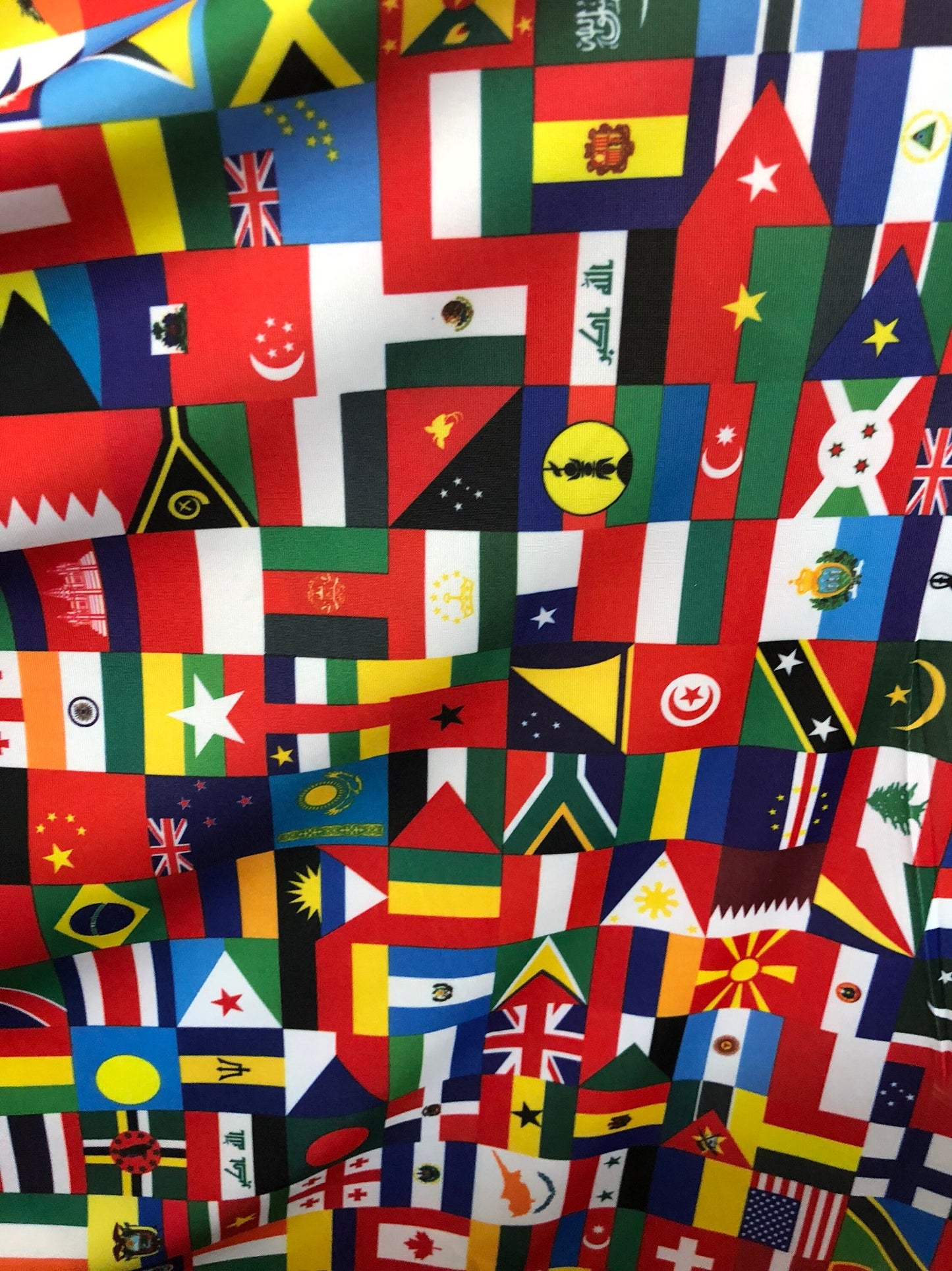 New International multi flags design printed on nylon spandex 4way stretch 58/60" Sold by the YD. Ships worldwide from Los Angeles CA USA.