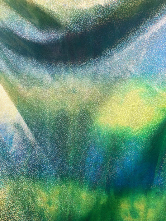 New hologram metallic tie dye blue/green on spandex base 4way stretch 58/60" Sold by the YD. Ships worldwide from Los Ángeles California.