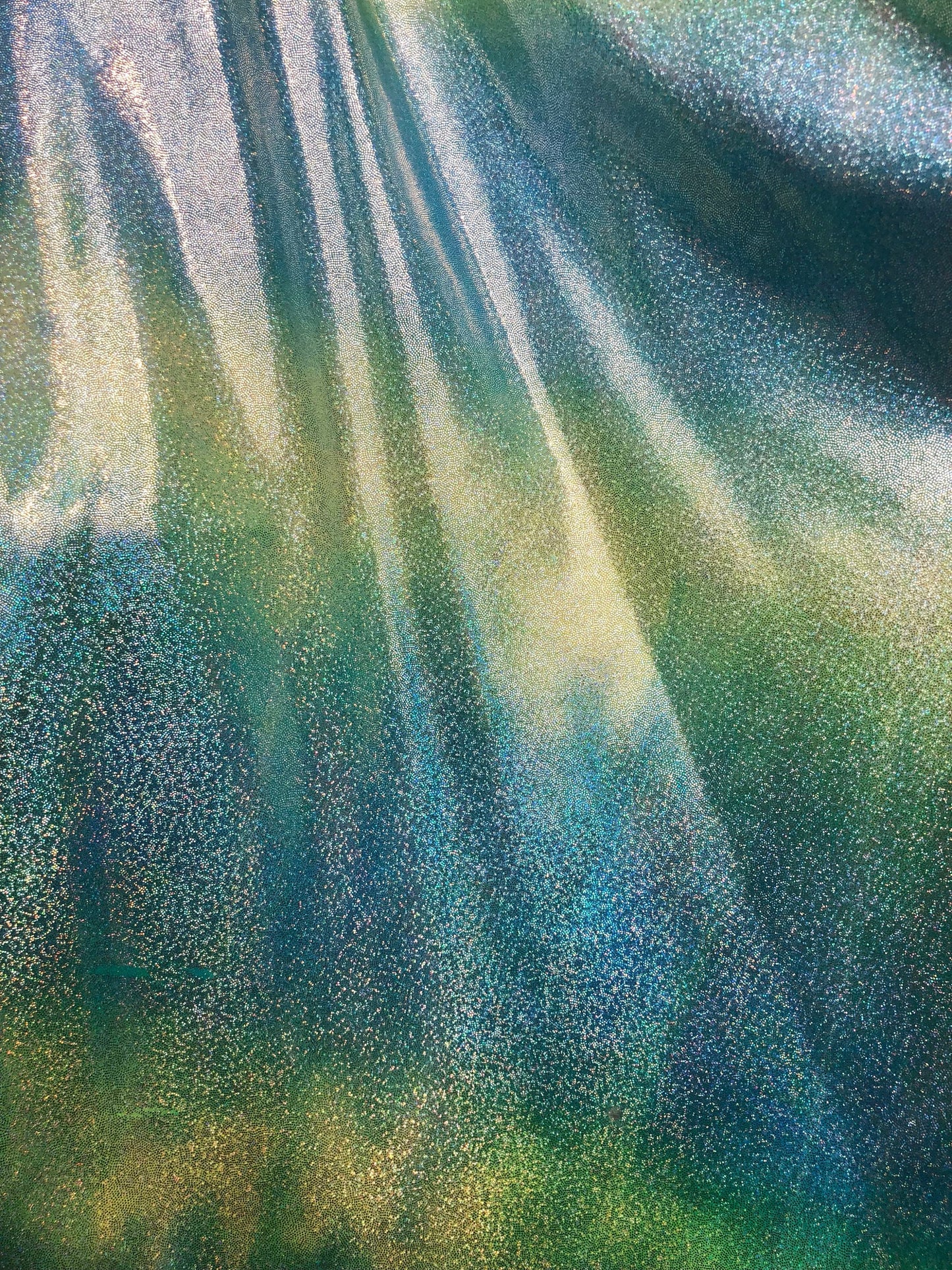 New hologram metallic tie dye blue/green on spandex base 4way stretch 58/60" Sold by the YD. Ships worldwide from Los Ángeles California.