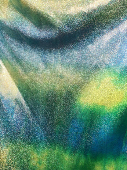 New hologram metallic tie dye blue/green on spandex base 4way stretch 58/60" Sold by the YD. Ships worldwide from Los Ángeles California.