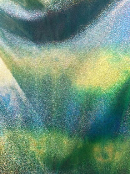 New hologram metallic tie dye blue/green on spandex base 4way stretch 58/60" Sold by the YD. Ships worldwide from Los Ángeles California.