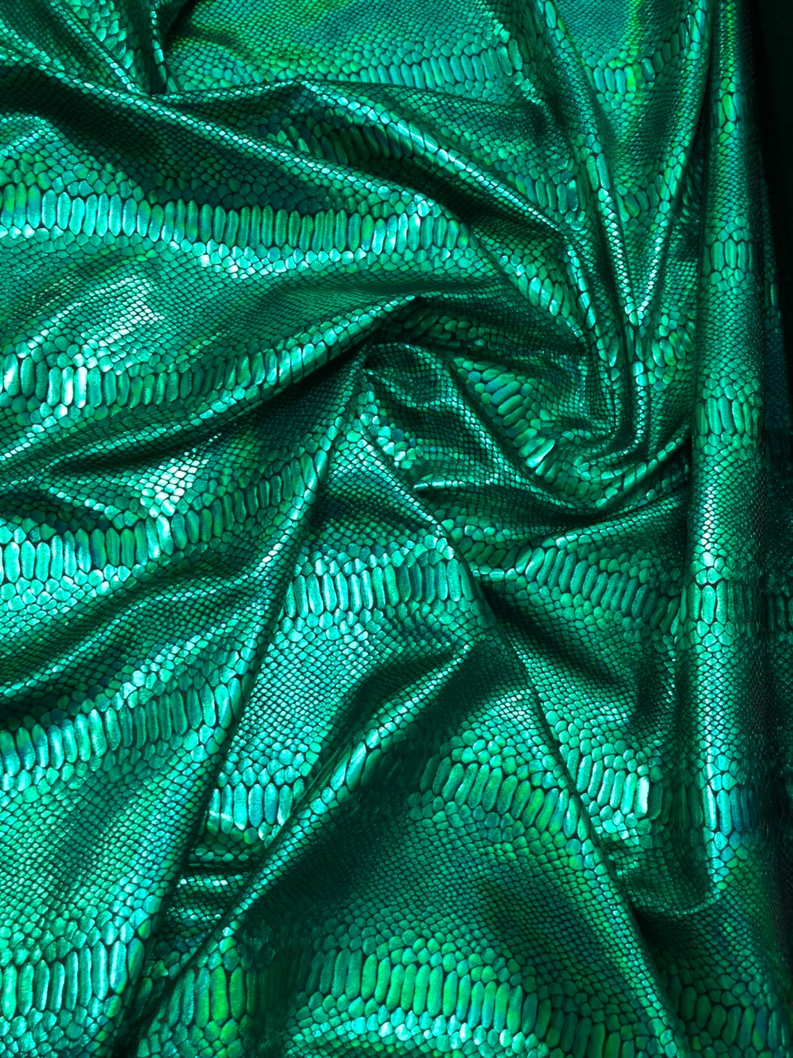 Snake design iridescent green metallic nylon spandex 4way stretch 58/60" Sold by the YD. Ships worldwide from Los Angeles California USA.