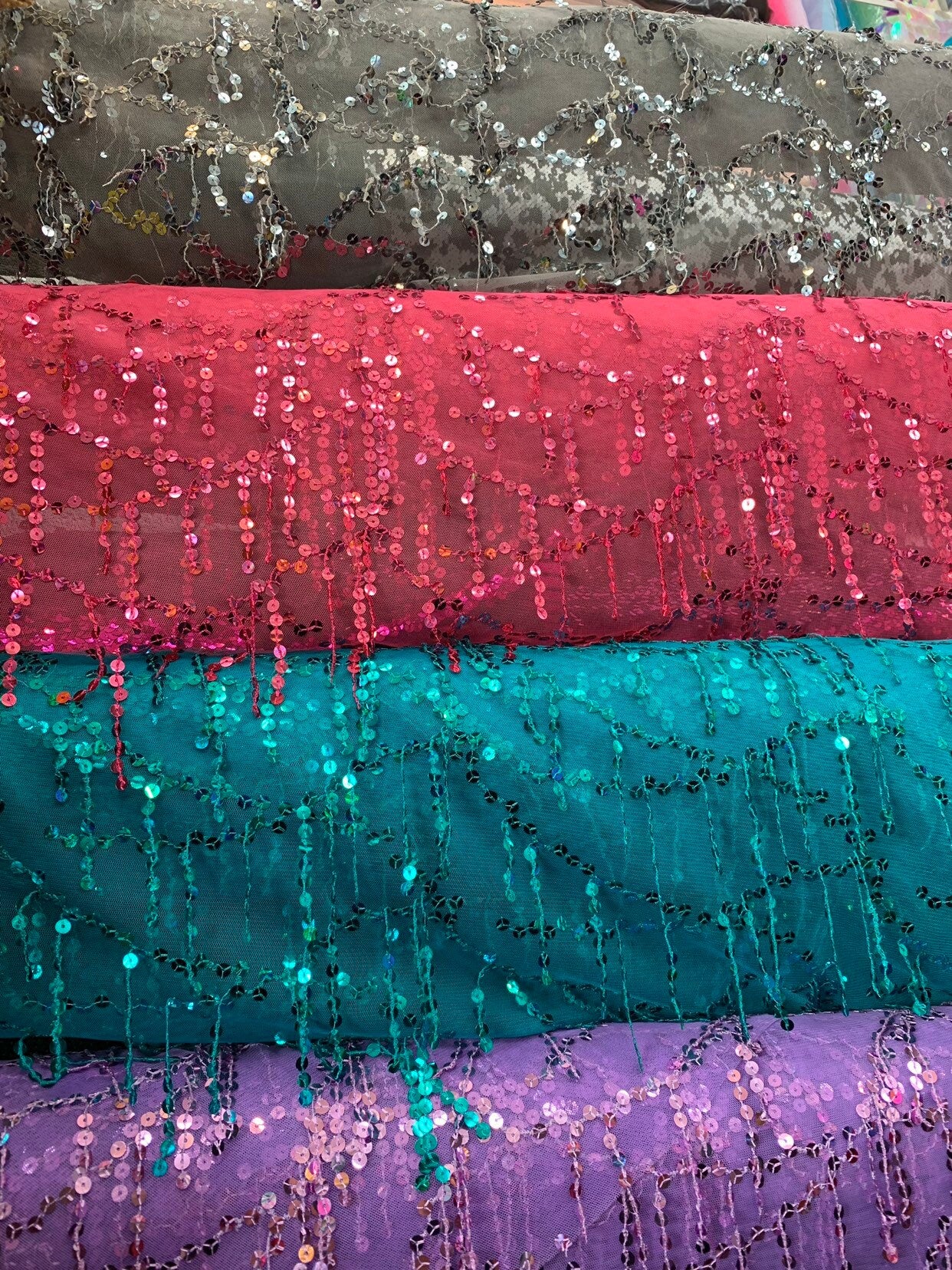 Hanging sequins all over on stretch mesh 2way 55/57" Sold by the YD. Ships worldwide from Los Angeles California USA.