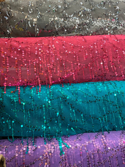 Hanging sequins all over on stretch mesh 2way 55/57" Sold by the YD. Ships worldwide from Los Angeles California USA.