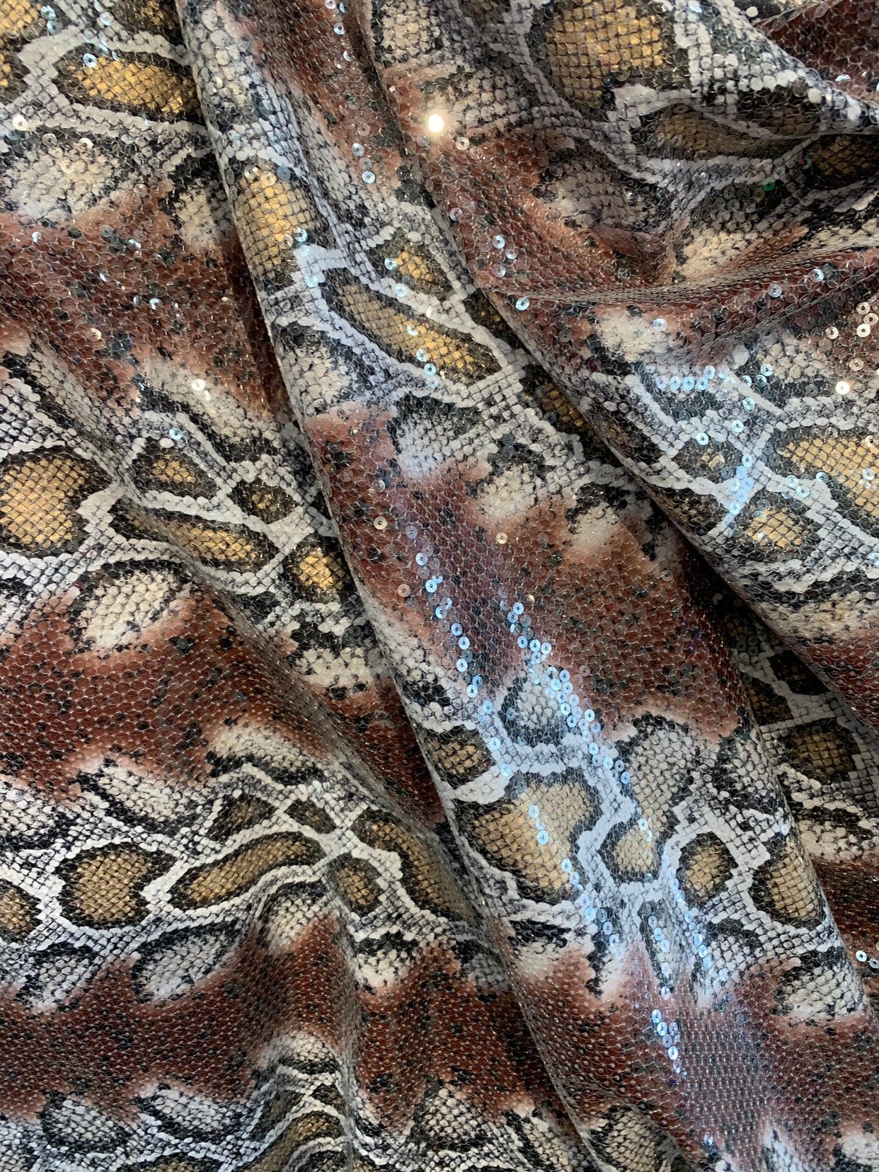 Snake design brown/gold with clear sequins all over spandex base 2way 58/60" Sold by the YD. Ships worldwide from Los Ángeles California USA