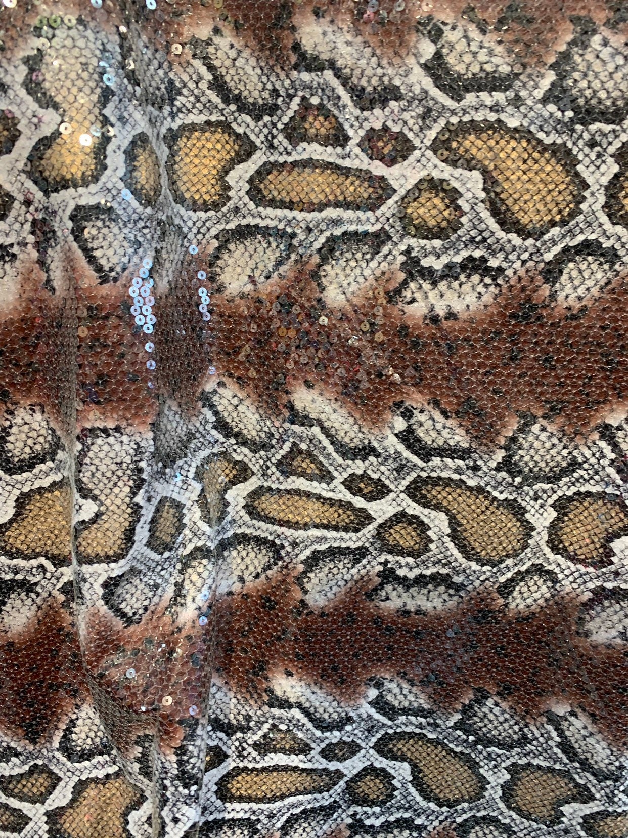 Snake design brown/gold with clear sequins all over spandex base 2way 58/60" Sold by the YD. Ships worldwide from Los Ángeles California USA