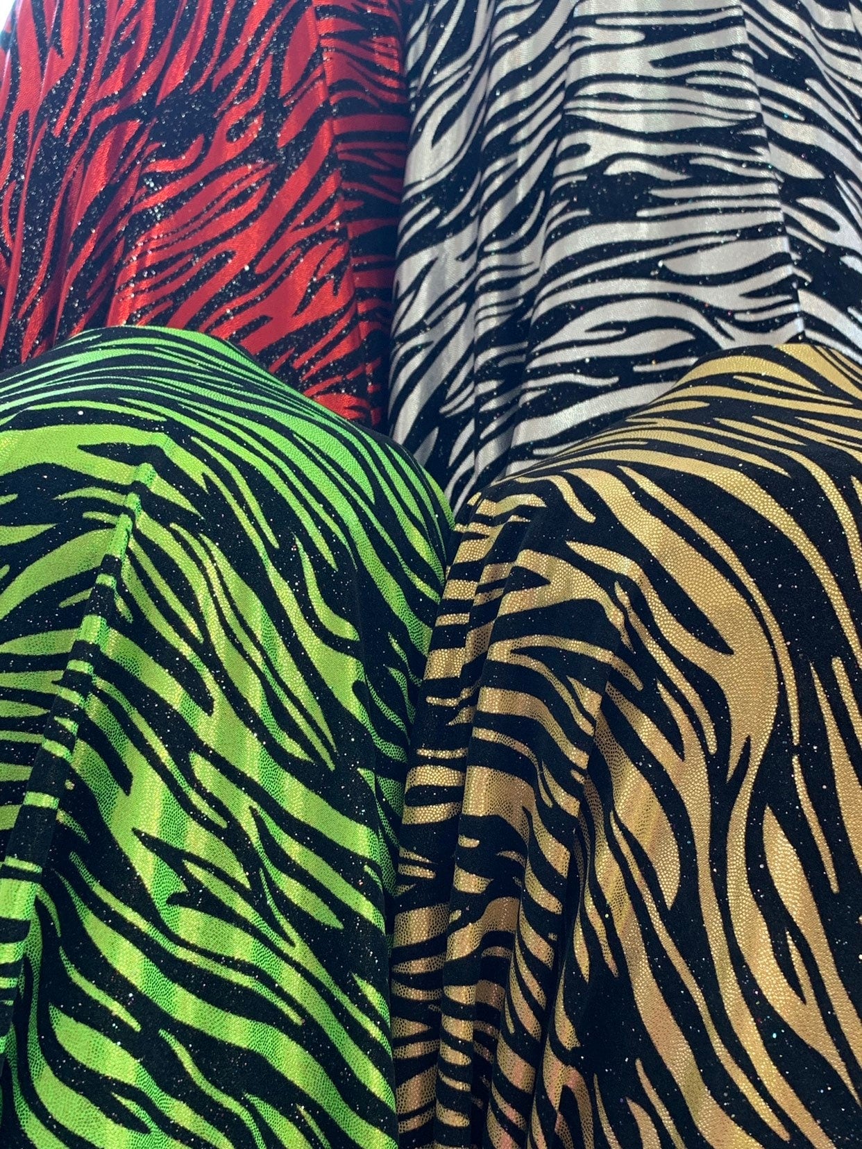 New zebra design with black flocking metallic nylon spandex 4-Way stretch 58/60" Sold by the YD. Ships worldwide from Los Angeles