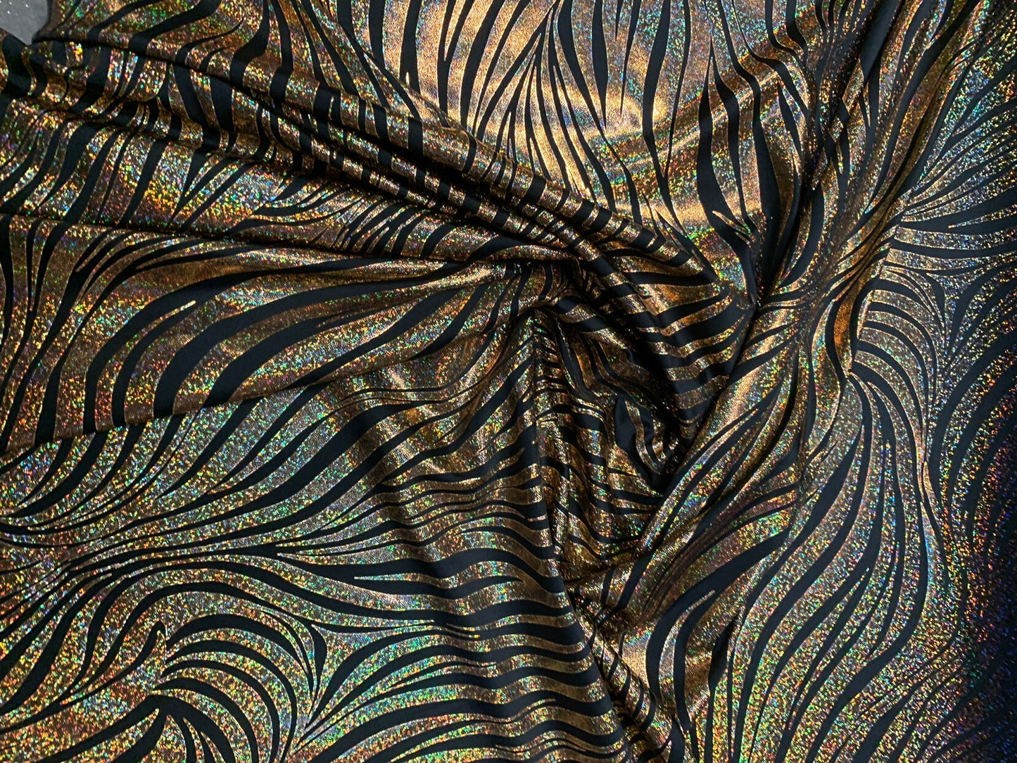 Metallic spandex zebra design w/exquisite hologram foil 4way stretch 58/60" Sold by the YD. Ships worldwide from Los Angeles California USA.