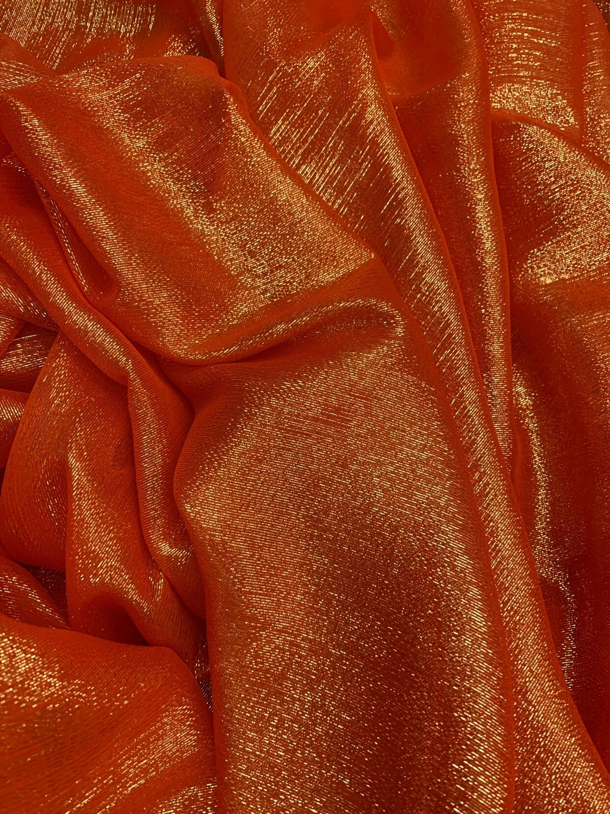 Silk metallic chiffon orange/gold 2way Stretch 44/45" Sold by the YD. Ships worldwide from Los Ángeles California USA.