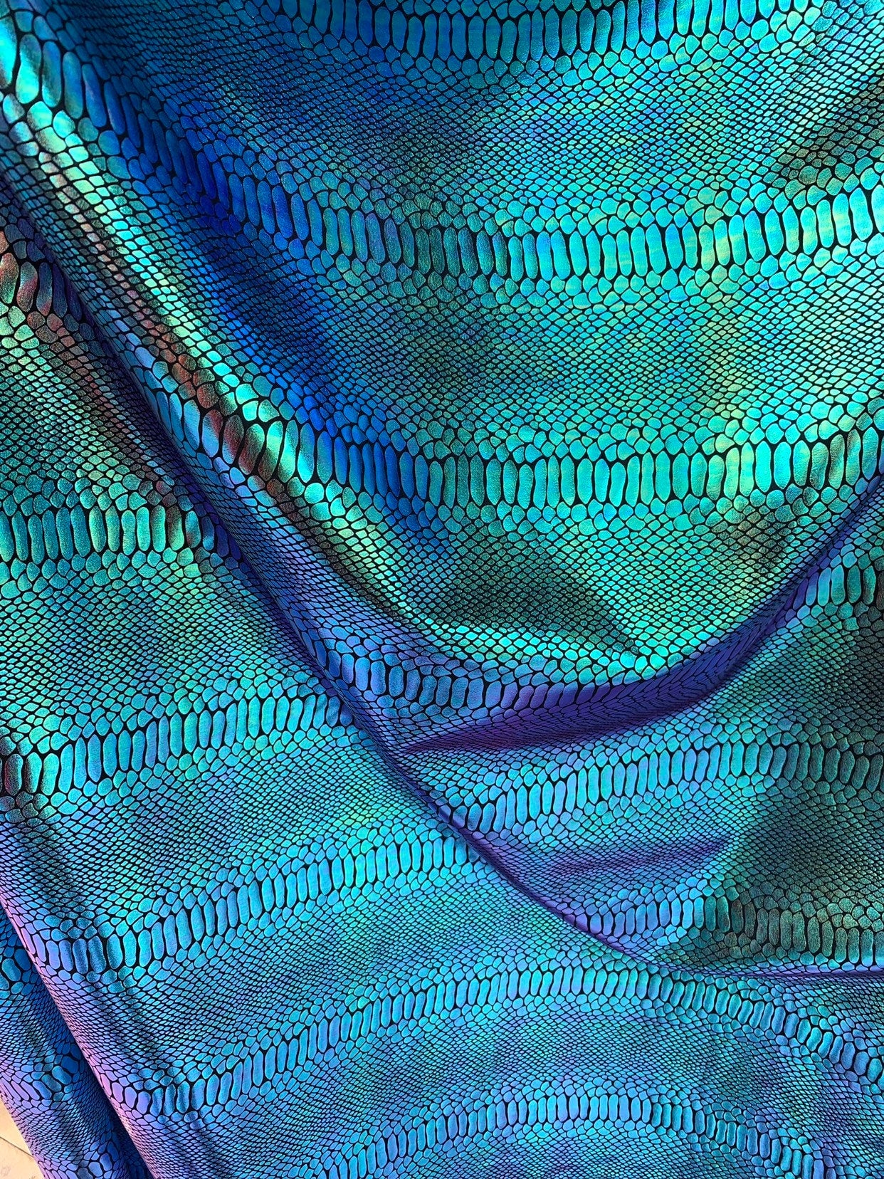 New Iridescent snake foil 2 tone blue/green metallic nylon spandex 4way stretch 58/60" Sold by the  YD. Ships worldwide from Los Angeles CA.