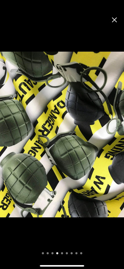 New Grenades caution danger print on nylon Spandex 4-way 58/60” Sold by the yard.  Print just as shown in the pictures. Ships worldwide